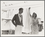 Tom Collins, manager of Kern migrant camp, talking with one of the members. California