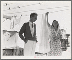 Tom Collins, manager of Kern migrant camp, talking with one of the members. California