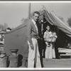 Tom Collins, manager of Kern migrant camp, California, with migrant mother and child