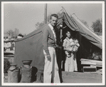 Tom Collins, manager of Kern migrant camp, California, with migrant mother and child