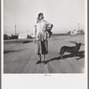 Cotton picker on her way to the cotton field. Kern migrant camp, California