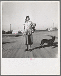 Cotton picker on her way to the cotton field. Kern migrant camp, California
