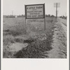 Real estate sign along the highway on which hundreds of drought refugees and migrant workers travel. Riverside County, California