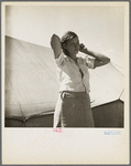 Woman in pea picker's camp. California. "I seen our corn dry up and blow over the fence back there in Oklahoma."
