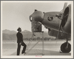 Plant quarantine inspectors examining plane at the Glendale Airport, California