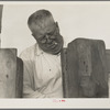 Henry Lotz closing the gate to the barns at the Midway City Dairy Association, near Santa Ana. Orange County, California. Seven families obtained a loan of seven thousand eight hundred fifty dollars from the Resettlement Administration payable in installments over a period of five years and and started a cooperative ...