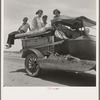 Migratory family traveling across the desert in search of work in the cotton at Roswell, New Mexico. U.S. Route 70, Arizona