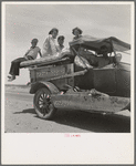 Migratory family traveling across the desert in search of work in the cotton at Roswell, New Mexico. U.S. Route 70, Arizona