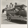 Migratory family traveling across the desert in search of work in the cotton at Roswell, New Mexico. U.S. Route 70, Arizona