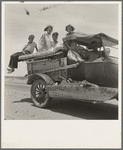 Migratory family traveling across the desert in search of work in the cotton at Roswell, New Mexico. U.S. Route 70, Arizona