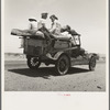 Migratory family traveling across the desert in search of work in the cotton at Roswell, New Mexico. U.S. Route 70, Arizona