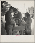 Plant quarantine inspectors examining goods bought in Juarez, Mexico before entering El Paso, Texas