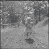 Little girl walking on dirt path
