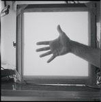 Hand framed by lightbox