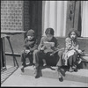 Children sitting on front steps. New York, NY