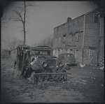 Cat sitting on a dilapidated car