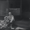 Seated man with baby. New York, NY