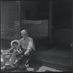 Seated man with baby. New York, NY