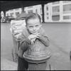 Boy leaning on a fire hydrant. New York, NY