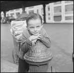 Boy leaning on a fire hydrant. New York, NY