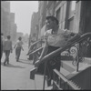 Woman standing on front stoop. New York, NY