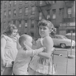 Girl holding a doll. New York, NY