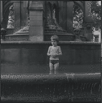 Child playing in fountain