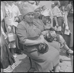 Seated women with head coverings