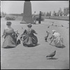 Girls feeding pigeons