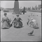 Girls feeding pigeons