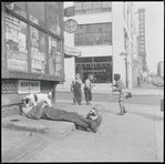 Man asleep on sidewalk. New York, NY