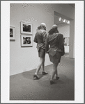 Two men in drag walking in MoMA galleries