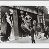 People on the street walking past a large Versace advertisement