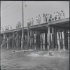 Pier with swimmers in foreground