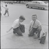 Two boys on a street corner. New York, NY