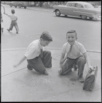 Two boys on a street corner. New York, NY