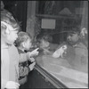 Children looking at pet store window. New York, NY