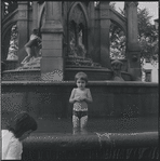 Child playing in fountain