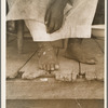 Fifty-seven year old sharecropper woman. Hinds County, Mississippi. Thin dimes around the ankles to prevent headaches