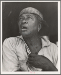 Fifty-seven year old sharecropper woman. Hinds County, Mississippi. Black beads hung between the breasts are good for heart trouble