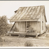 Cotton field hand sitting on her porch on Sunday afternoon. Near Blytheville, Arkansas