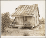 Cotton field hand sitting on her porch on Sunday afternoon. Near Blytheville, Arkansas