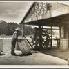 Turpentine still near Valdosta, Georgia. The "cooper" makes barrels to hold the gum