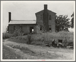 A plantation house decaying and now vacant but for two rooms occupied by an old couple, Negro tenants. Greene County, Georgia