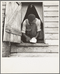 Negro field hand getting ready to go to town on a Saturday afternoon. His wages are seventy-five cents a day and cabin. He has six children [Greene County, Georgia]