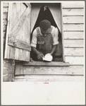 Negro field hand getting ready to go to town on a Saturday afternoon. His wages are seventy-five cents a day and cabin. He has six children [Greene County, Georgia]