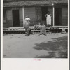 Negro wage laborer and part of his family. He is coming home from the commissary with a week's rations. Macon County, Georgia
