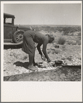 Young Negro wife cooking breakfast, outskirts of El Paso, Texas. "Do you suppose I'd be out on the highway cooking my steak if I had it good at home?" Occupations: hotel maid, cook, laundress