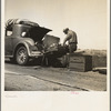 Car trouble on west side, Highway no. 33. In San Joaquin Valley. Formerly a California cowhand and roving laborer, now with wife, he follows the fruit. "My uncle homesteaded here sixty years ago. I'm lower on money than at any time"