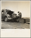 Car trouble on west side, Highway no. 33. In San Joaquin Valley. Formerly a California cowhand and roving laborer, now with wife, he follows the fruit. "My uncle homesteaded here sixty years ago. I'm lower on money than at any time"